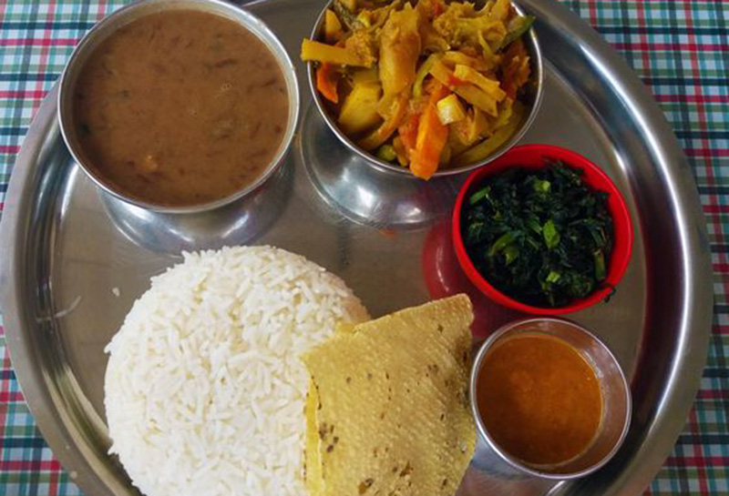 The local Nepali thali with rice, lentils, curry and pickle
