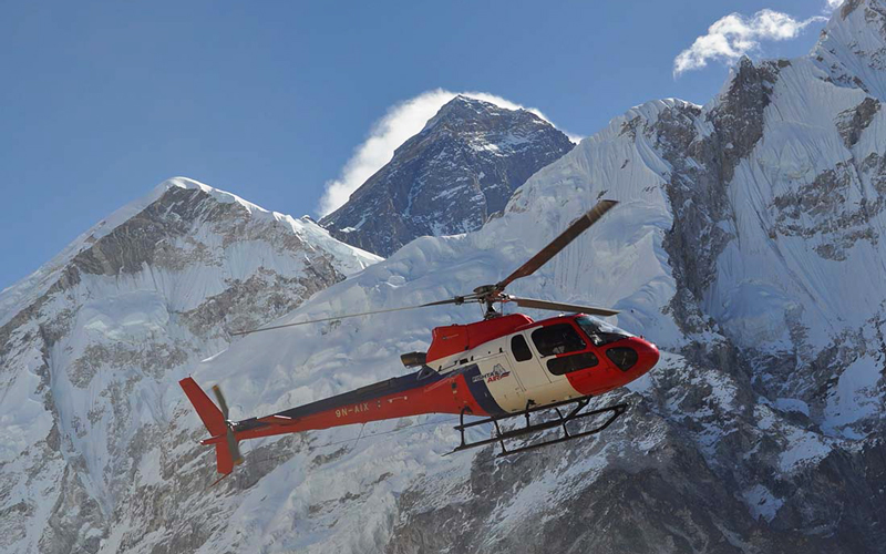 Helicopter flying with mount Everest in the backdrop