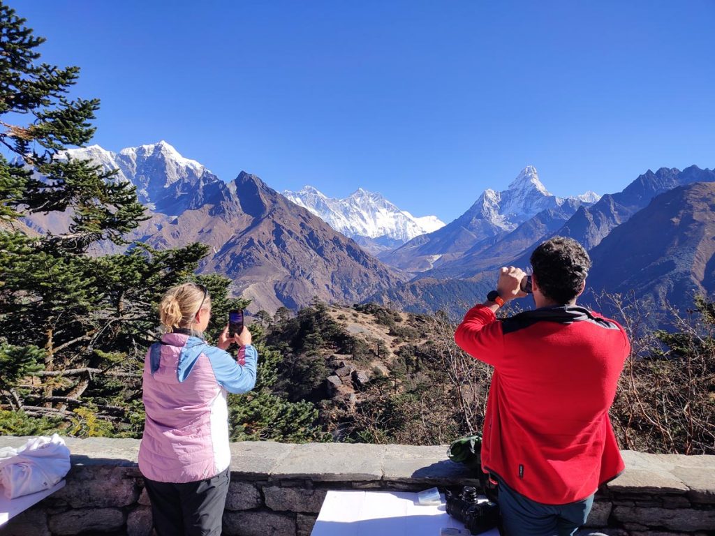 Trekkers capturing the view of Everest, Lhotse and Amadablam from Hotel Everest View