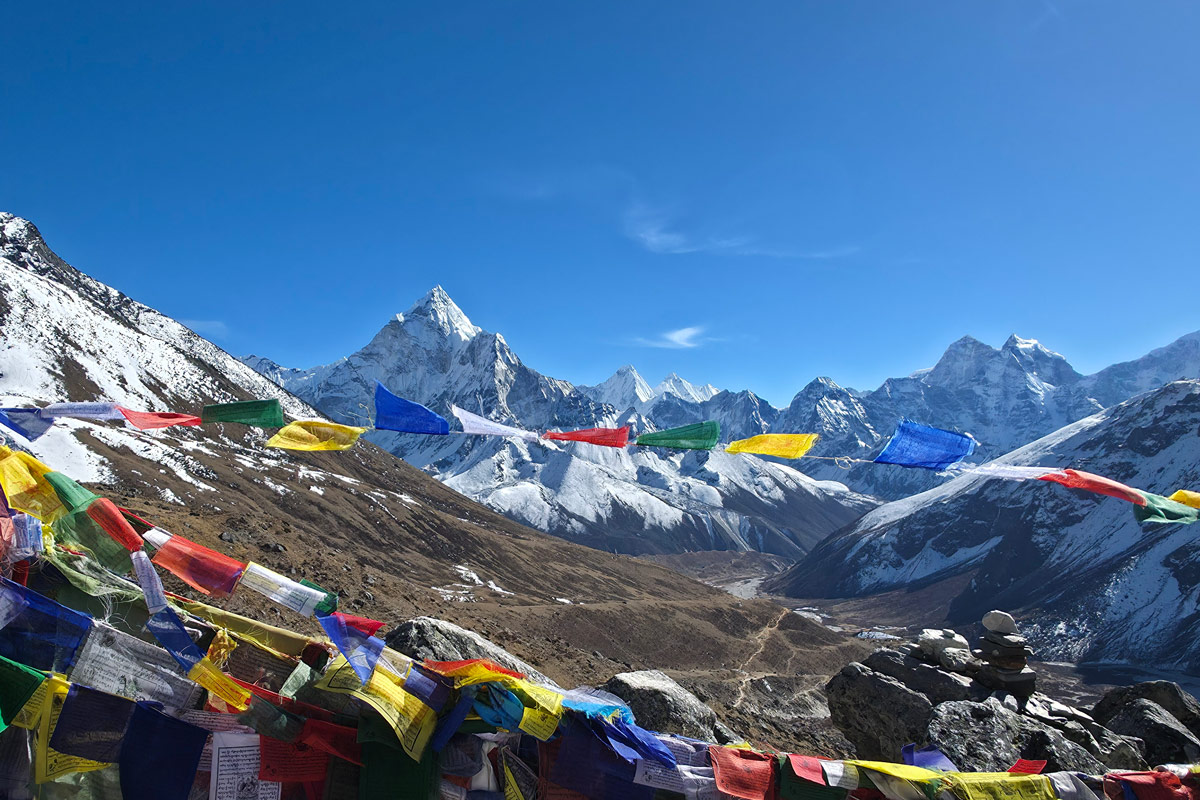 Panoramic Himalayan mountain views from Thukla Pass with prayer flags Panoramic Himalayan mountain views from Thukla Pass with prayer flags