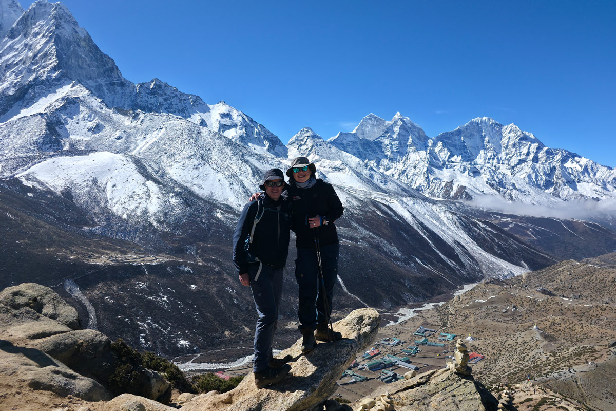 Trekkers at Nangkartshang Peak overlooking Dingboche with stunning views of Thamserku and Kangtega Trekkers at Nangkartshang Peak overlooking Dingboche with stunning views of Thamserku and Kangtega