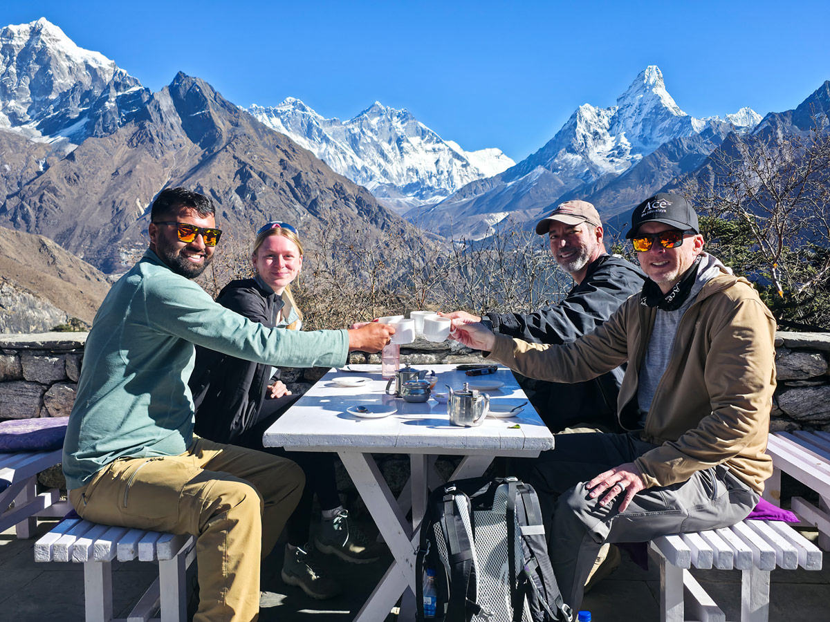 Trekkers enjoying tea with stunning Everest views at Hotel Everest View Trekkers enjoying tea with stunning Everest views at Hotel Everest View
