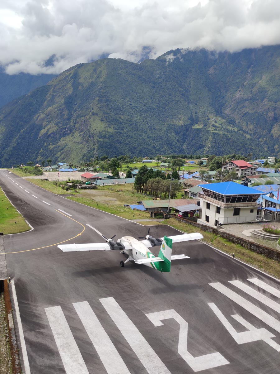 Airplane taking off from Lukla airport runway