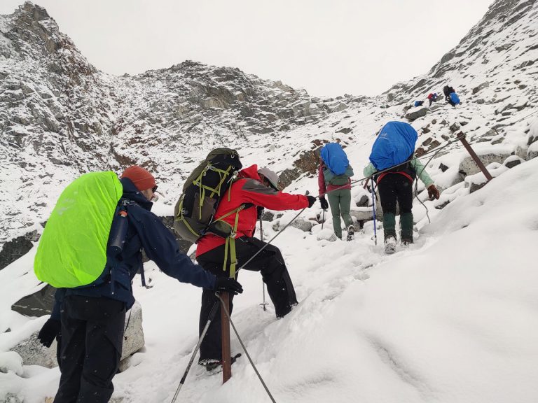 Trekkers climbing to reach Chola Pass Summit