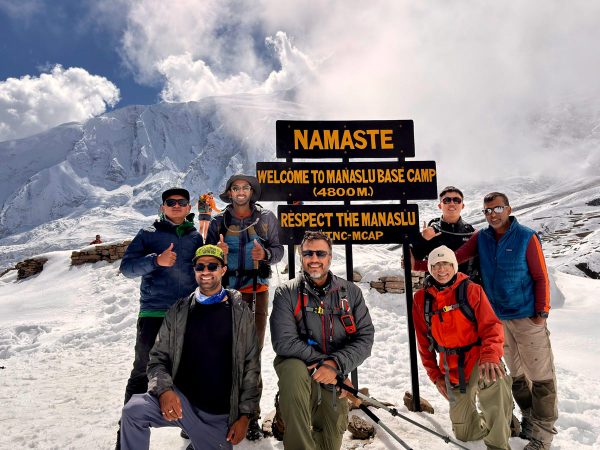Trekkers capturing memories at Manaslu Base Camp on the Manaslu Circuit