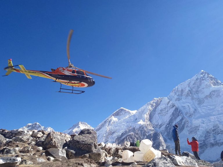 Helicopter taking off from Kala Patthar
