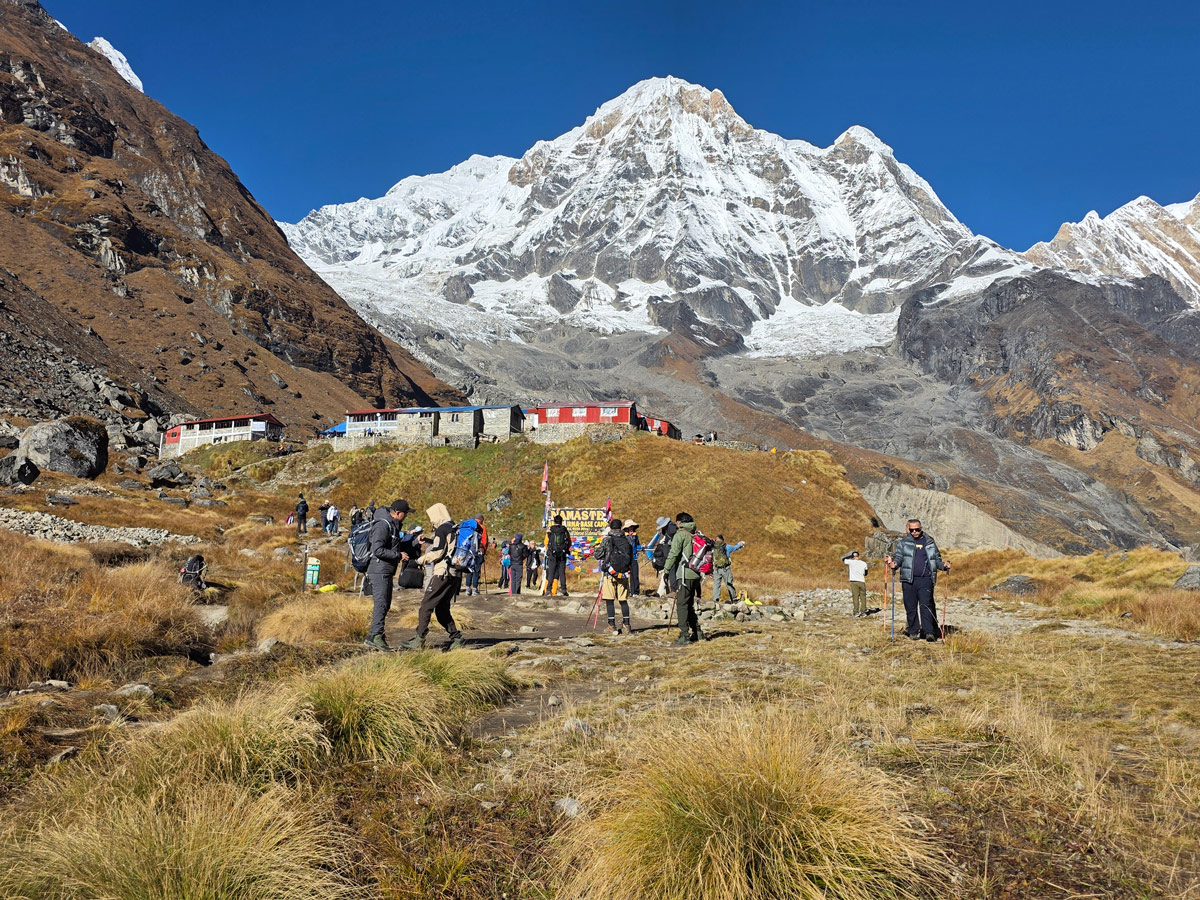 Best Time for Annapurna Base Camp Trek: Complete Seasonal Guide 4 Trekkers at Annapurna Base Camp during the autumn season