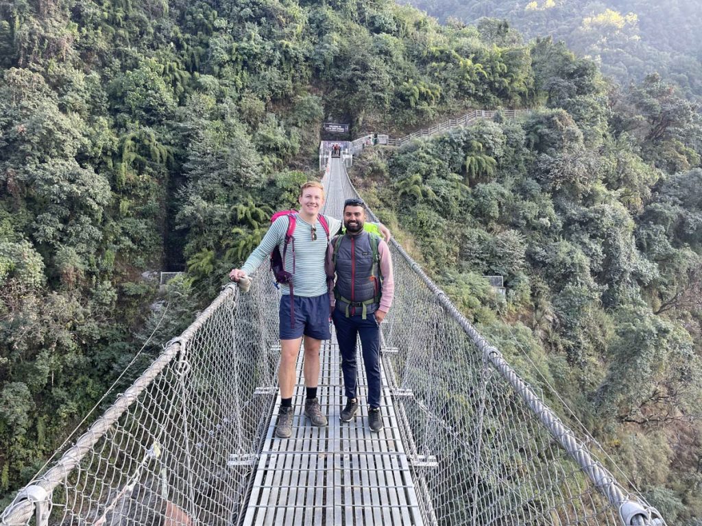 Hikers crossing the picturesque Jhinu Suspension Bridge along the Annapurna Base Camp trek