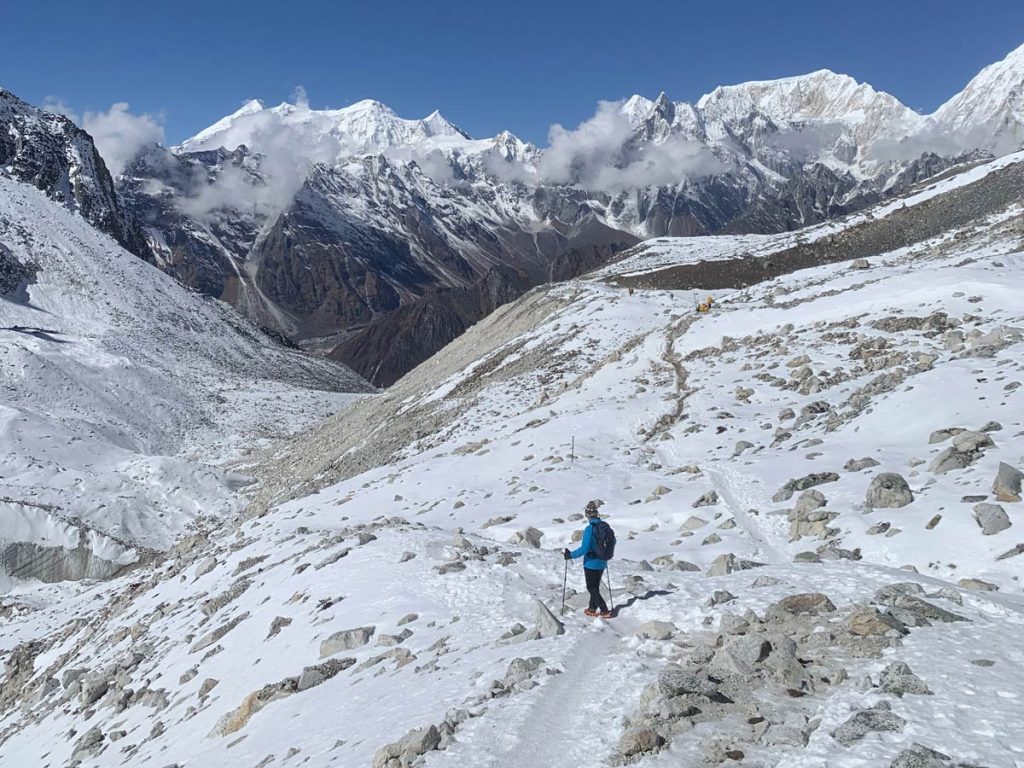 A trekker on the way from Larkya La Pass to Bimthang