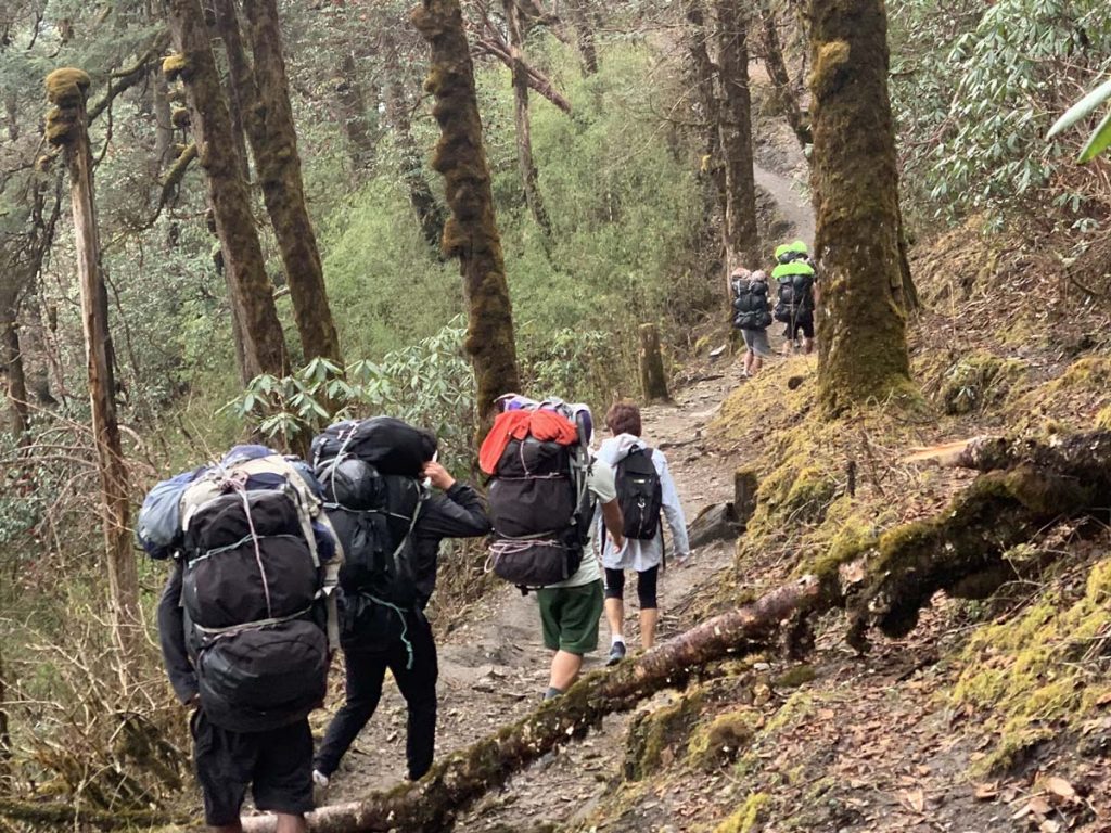 Porters carrying bags along the ABC trail