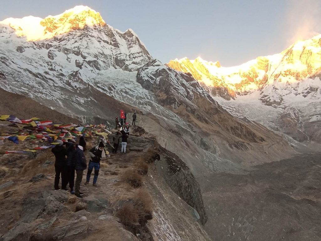 Trekkers enjoying early morning sunrise from Annapurna Base Camp