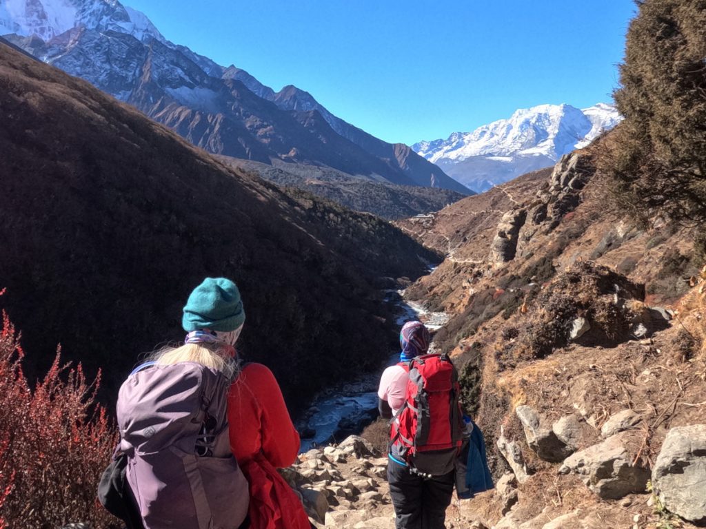 Trekkers with backpacks on the iconic Everest Base Camp trail.