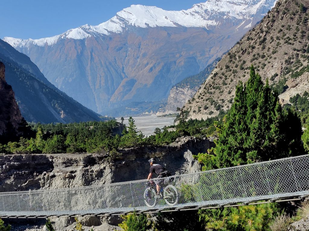 Crossing suspension bride during Annapurna Circuit Biking