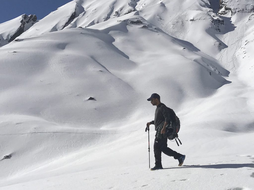 Trekker walking on snowy trail of Annapurna Base Camp route