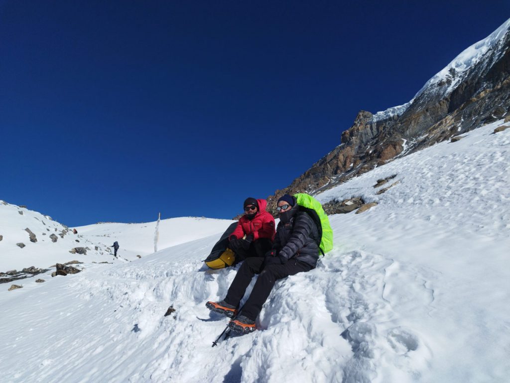 Trekkers embark on the snowy path towards Thorong La Pass.