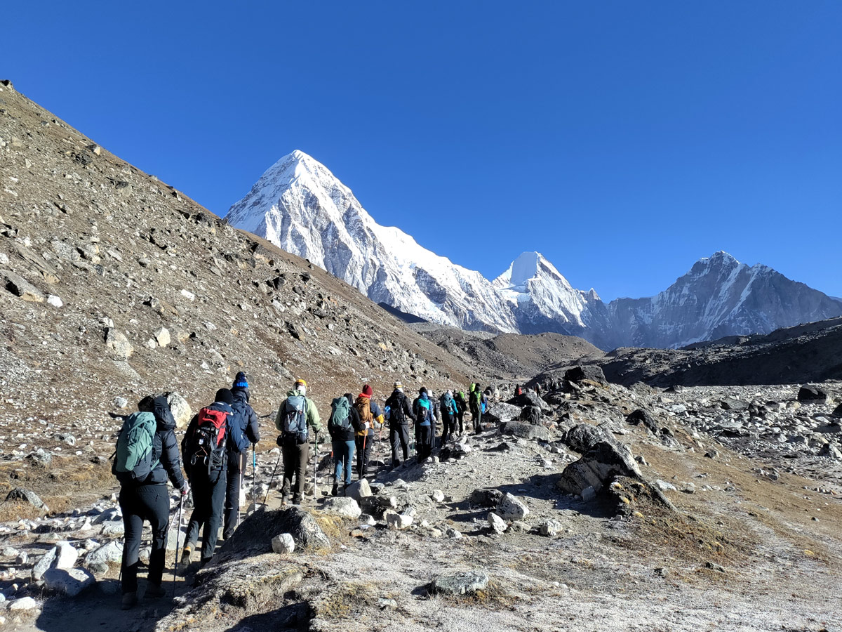 Trekkers approaching Gorakshep with Mt Pumori in the horizon