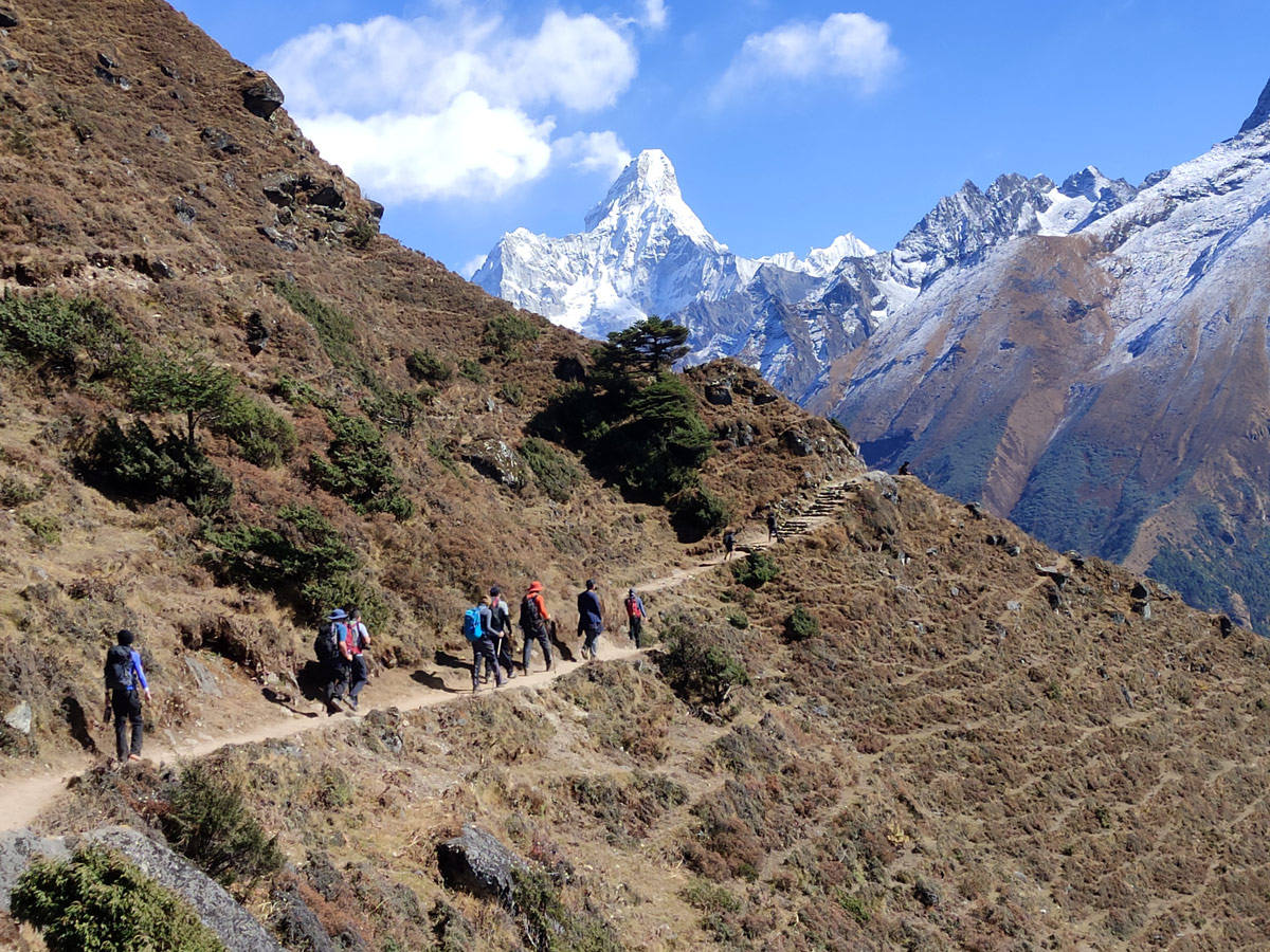 Trekkers on the Everest base camp trail with Amadablam in the horizon