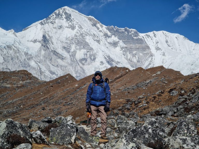 A trekker on the way to Gokyo, with the towering Mount Cho Oyu in the background