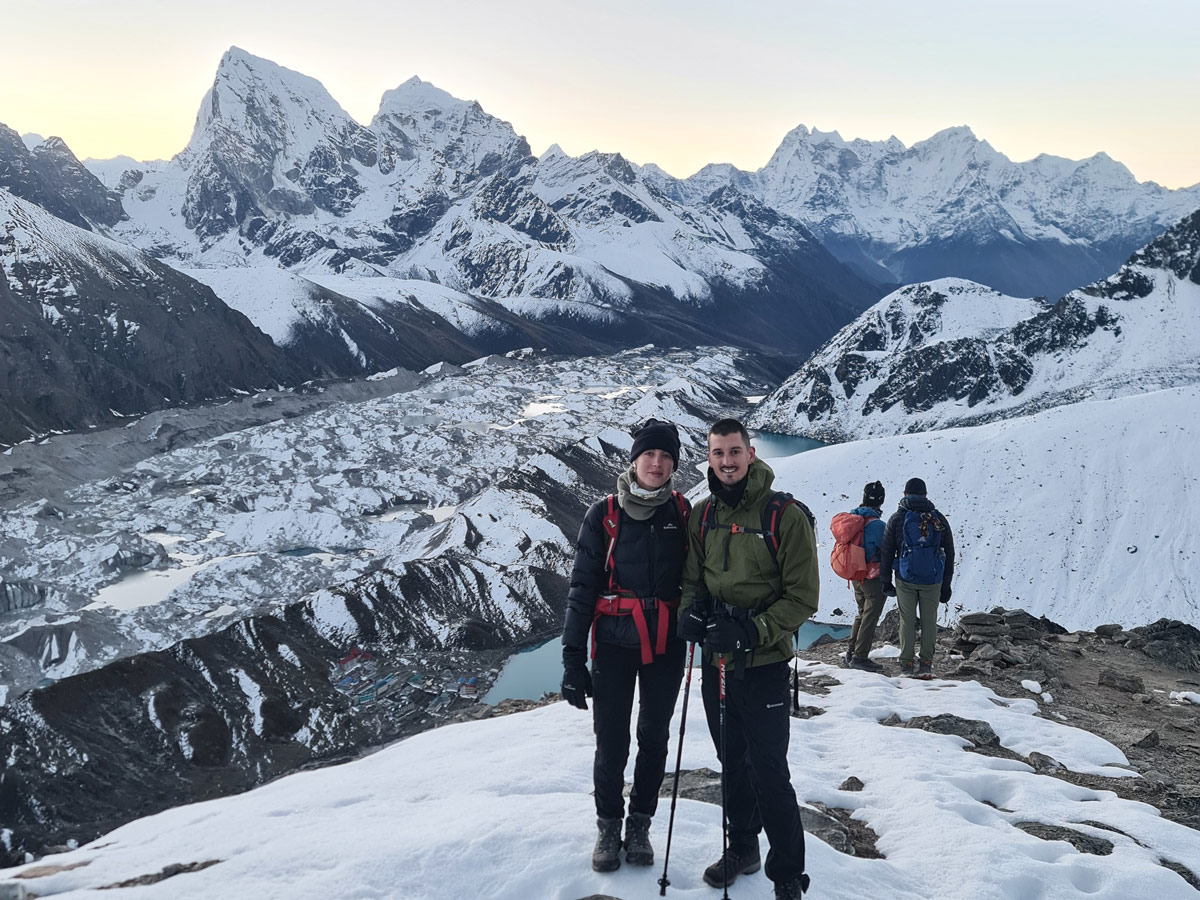 What to Expect on a Trek in Nepal? 11 Trekkers at Gokyo Ri, with a snowy view of Gokyo Valley and glacier