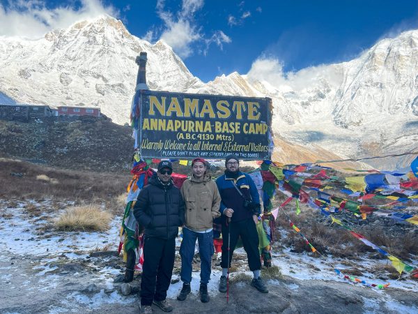 Trekkers stand proudly at Annapurna Base Camp