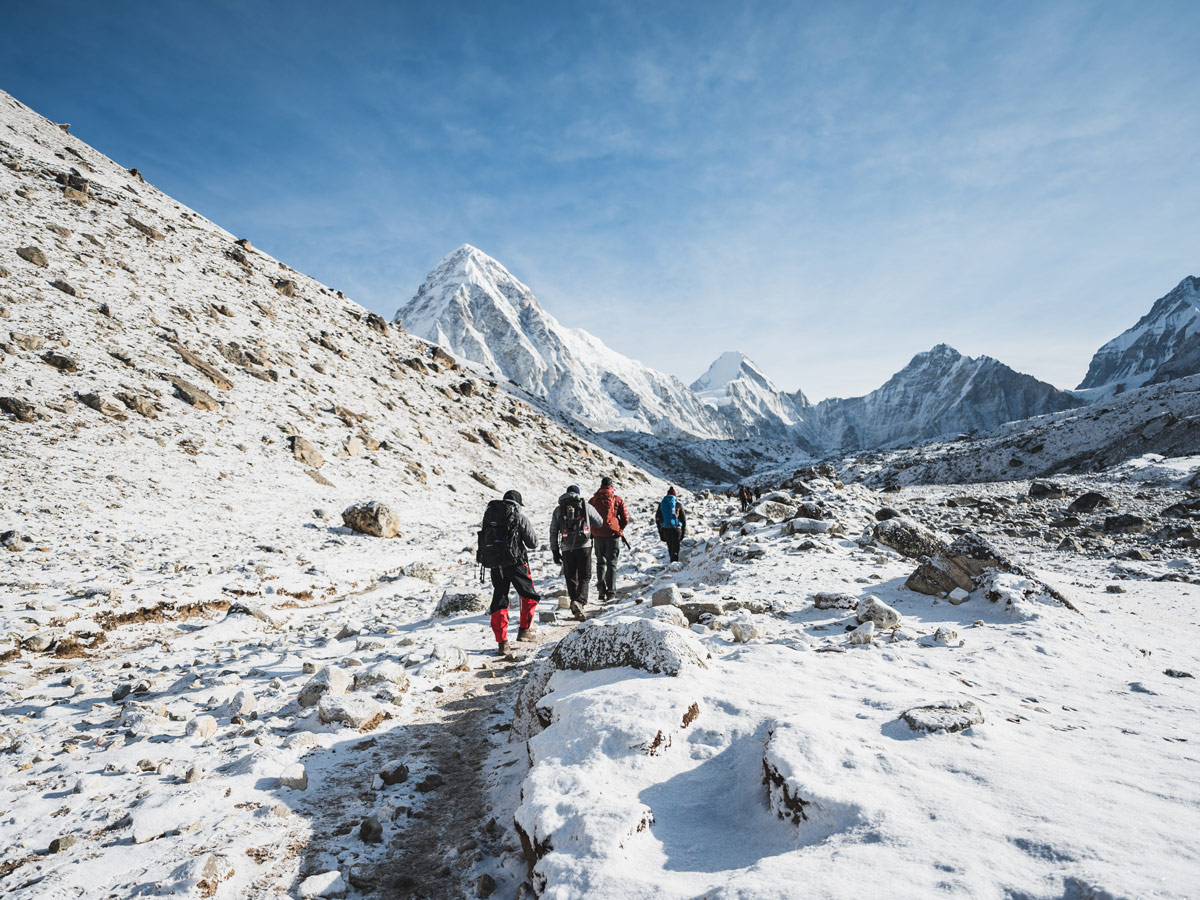 How to Choose the Best Trekking Company in Nepal 1 Trekkers on the way to Gorakshep with Mt. Pumori in horizon