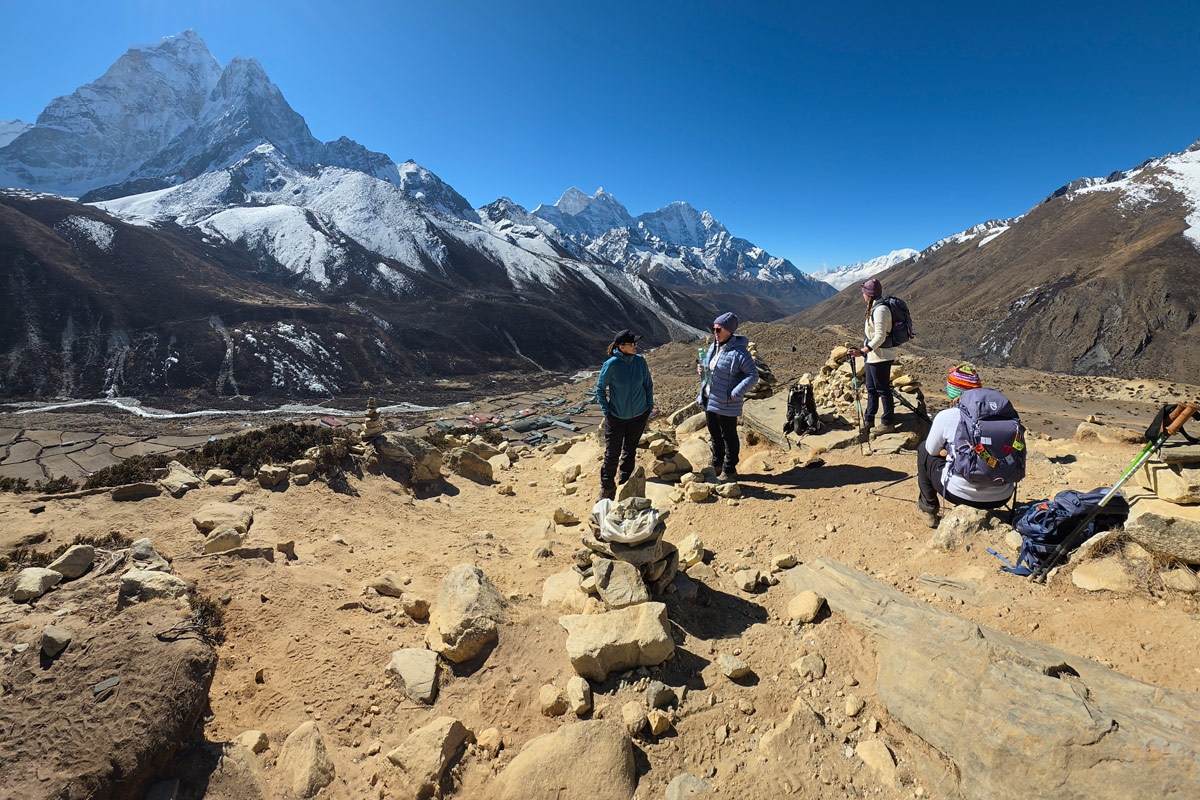 Trekkers resting on the Nangkartshang acclimatization hike. Trekkers resting on the Nangkartshang acclimatization hike.