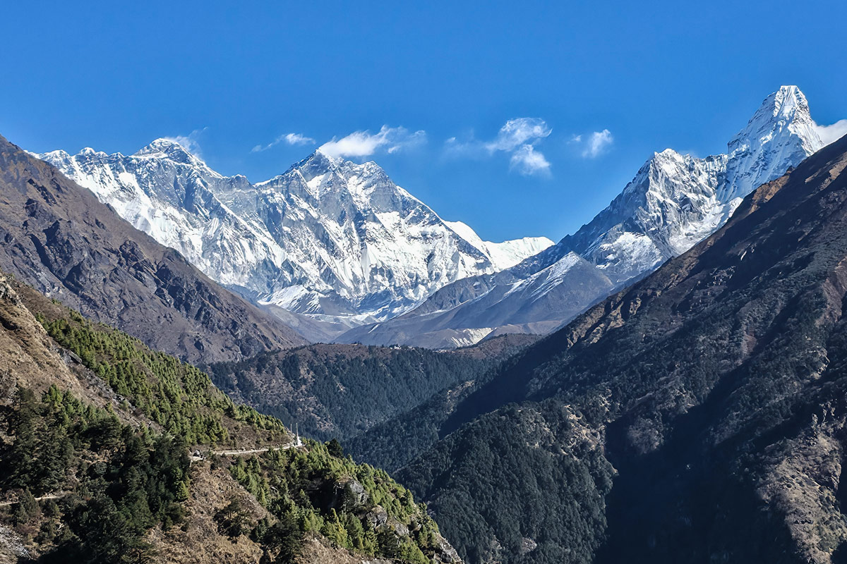 Everest, Lhotse and Ama Dablam stand tall on the way to Tengboche from Namche Bazaar Everest, Lhotse and Ama Dablam stand tall on the way to Tengboche from Namche Bazaar