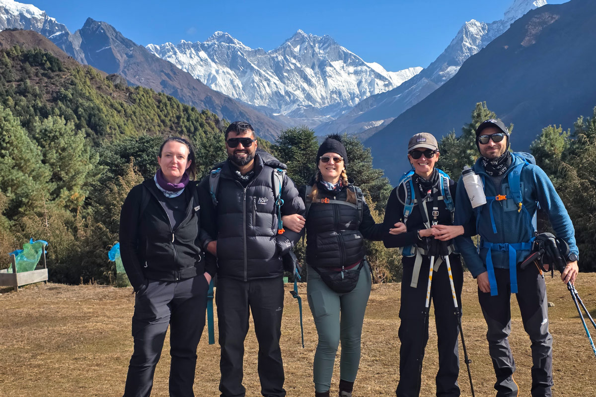 Trekkers pose at the iconic Namche Bazaar viewpoint Trekkers pose at the iconic Namche Bazaar viewpoint